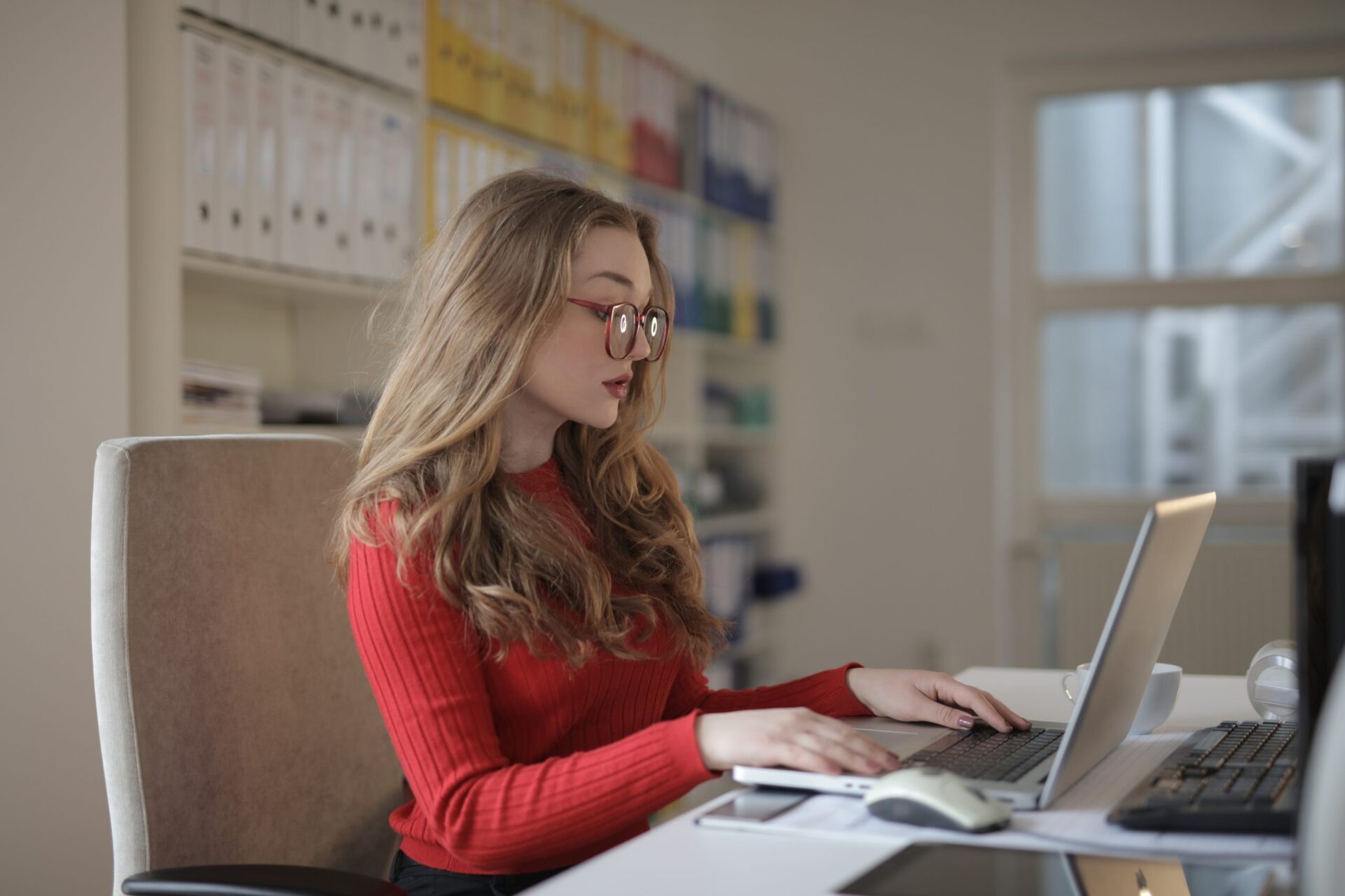 woman-in-red-long-sleeve-shirt-wearing-eyeglasses-using-3791130
