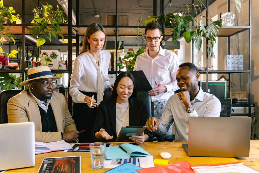 Racially diverse HR group of three men and two women meeting