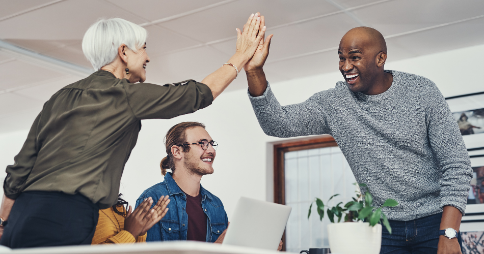 2 colleagues high-five after turnover rate discussion
