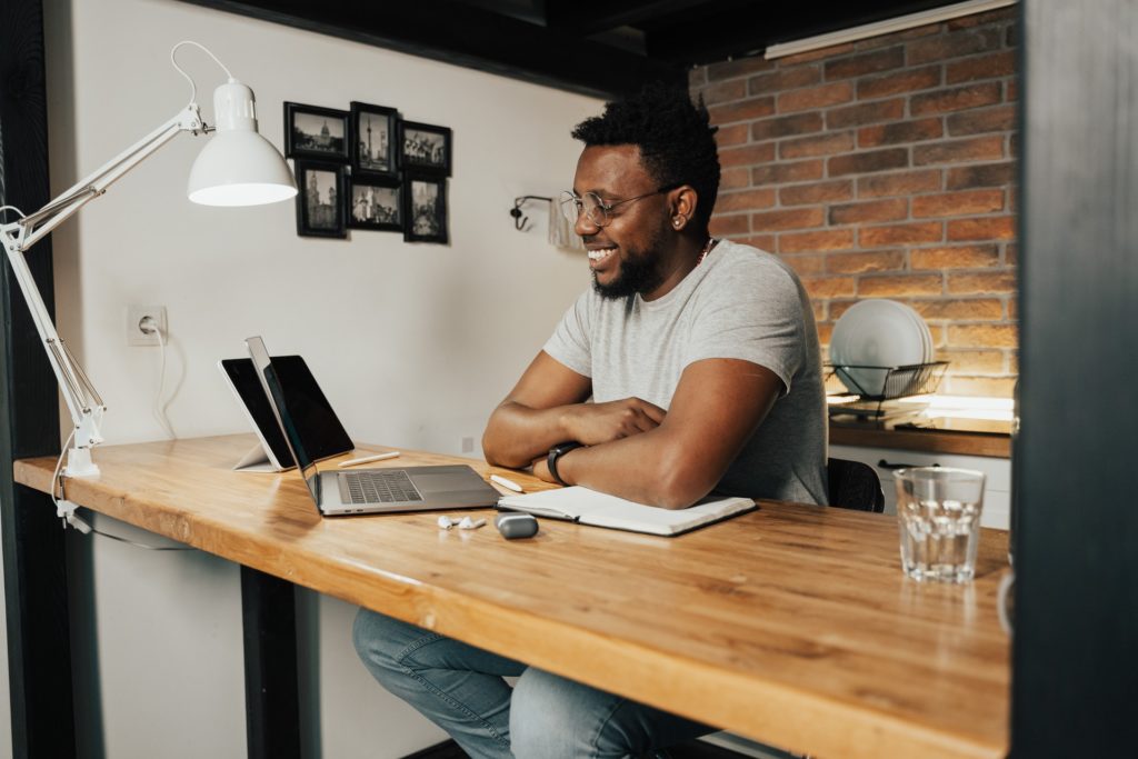 Man at desk using people management skills remotely