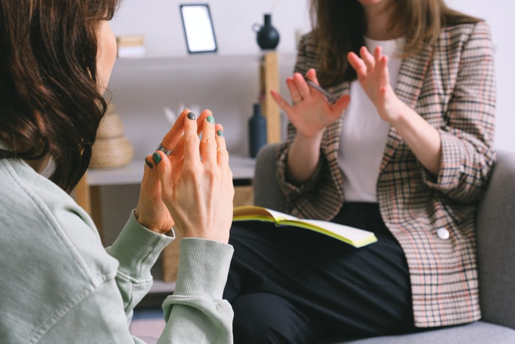 Two women gesturing with hands about team communication