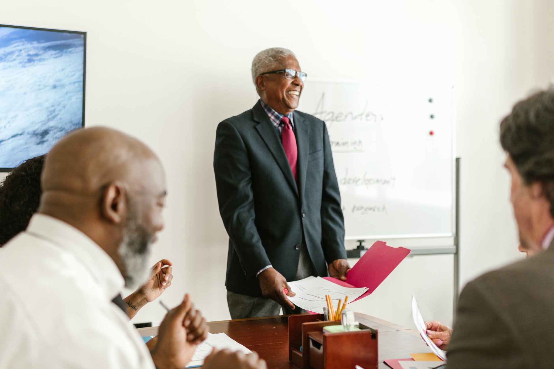 four-colleagues-office Professional Black man and colleagues doing a project review