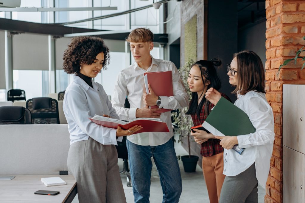 Group of employees standing and discussing HR policies