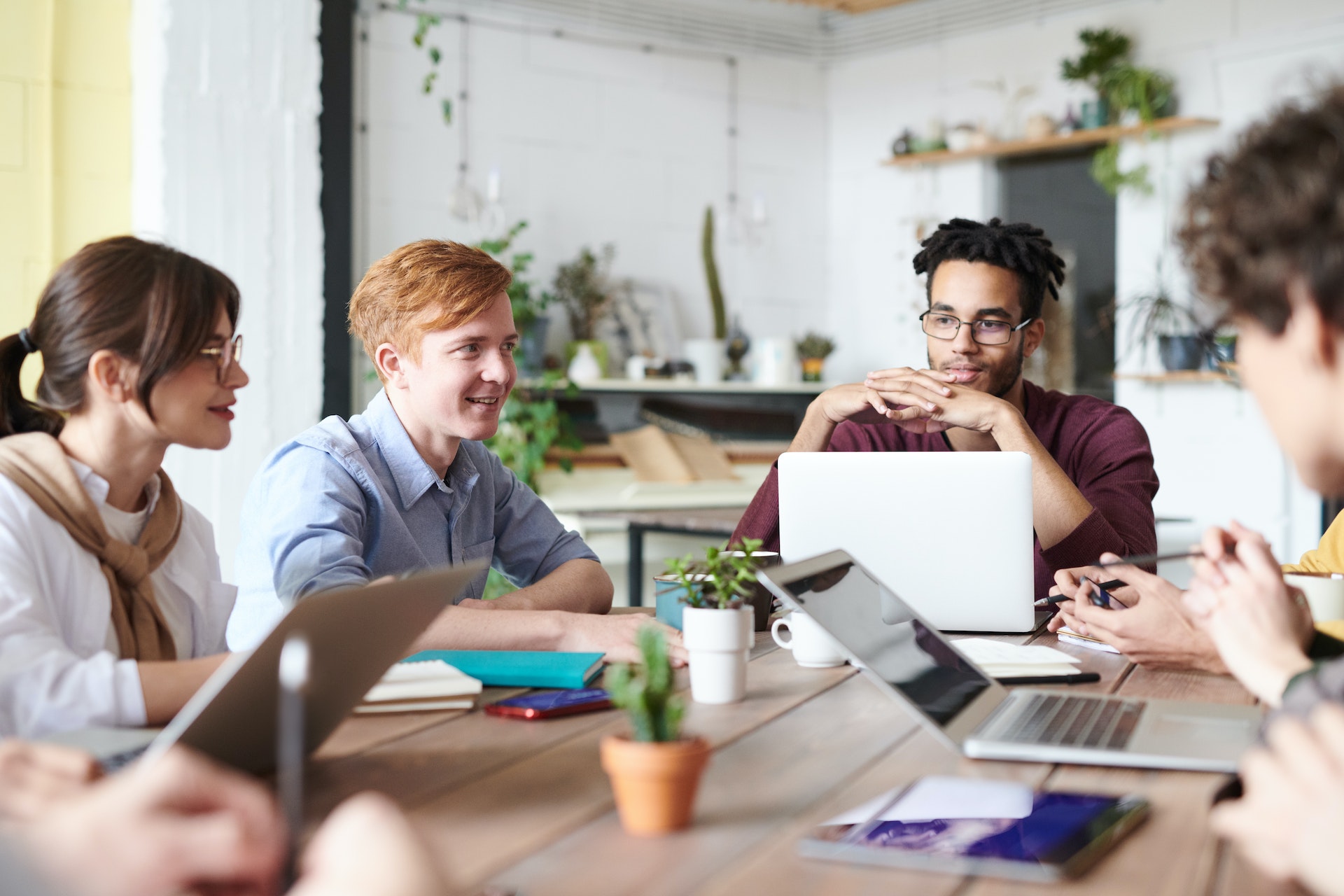 group-colleagues-meeting-desk Diverse group of employees discussing employment equity
