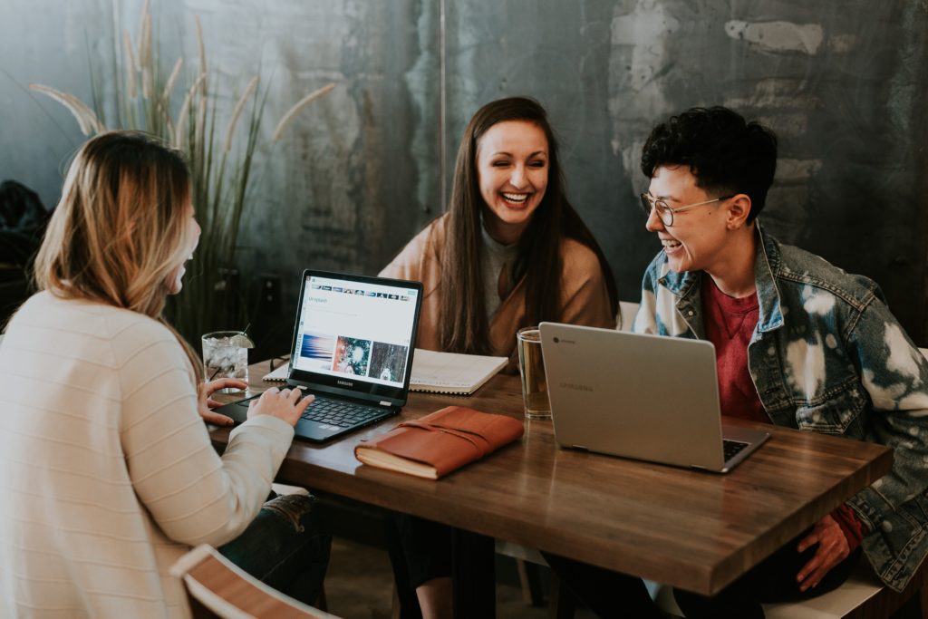 Diverse group of three women discussing employee engagement action plan