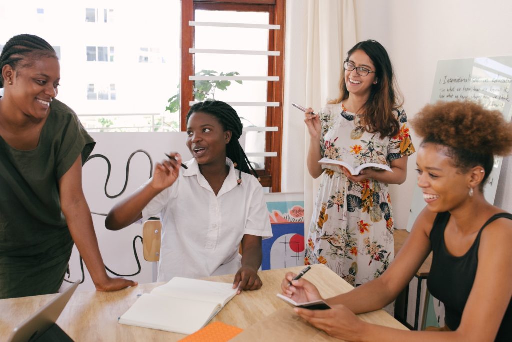 Woman of colour chief happiness officer meeting with other women of colour