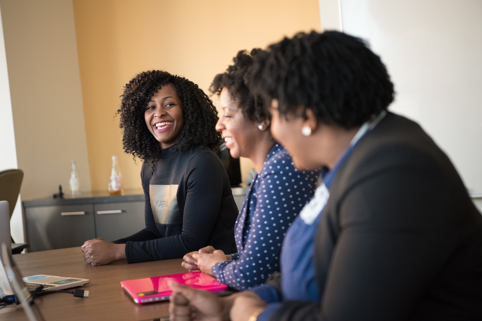 3-corporate-black-women Three professional Black women happily discussing strategy execution