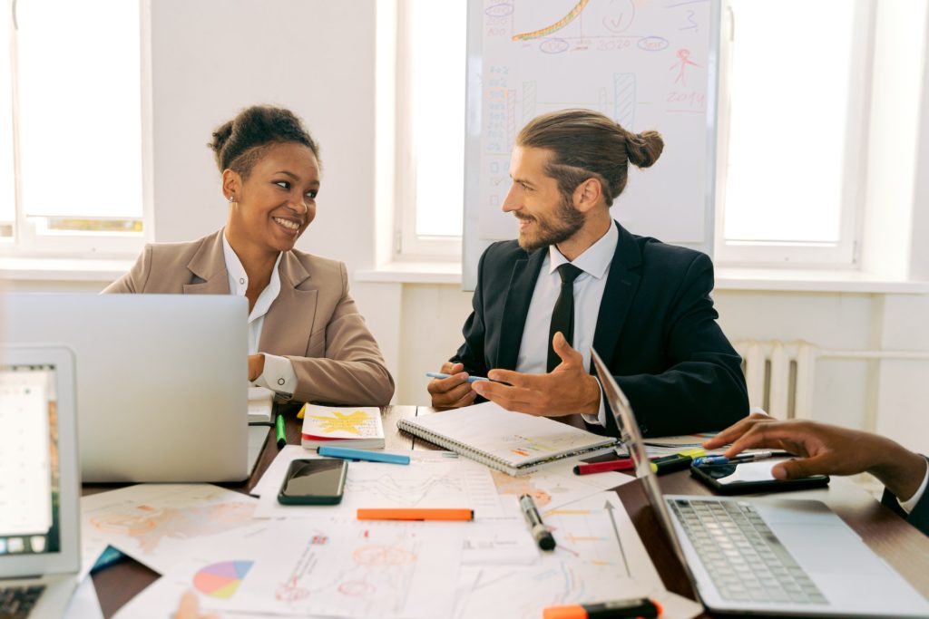 Black woman and white man discussing career development plan