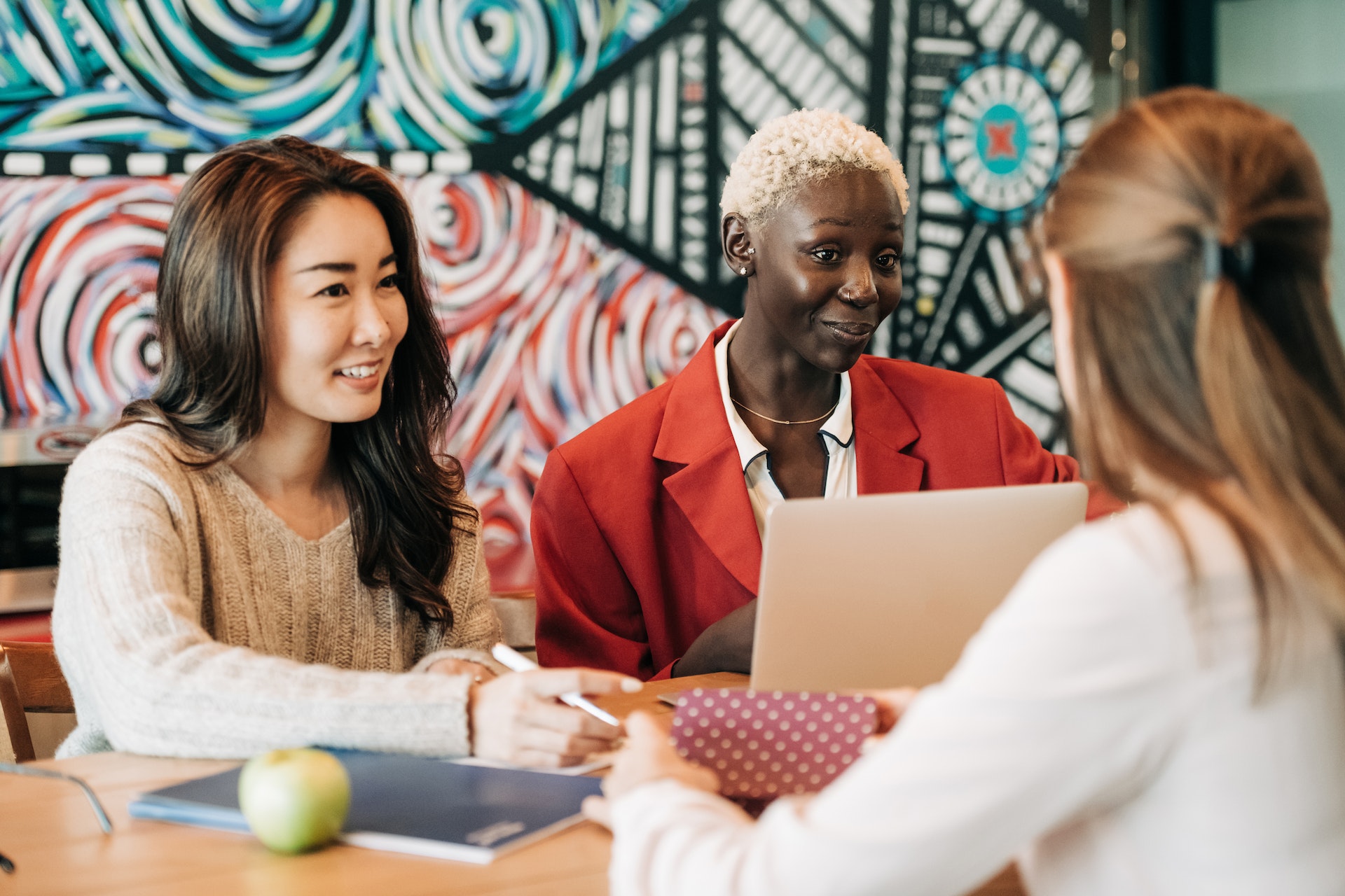 three-women-meeting Three women high performers in casual work meeting