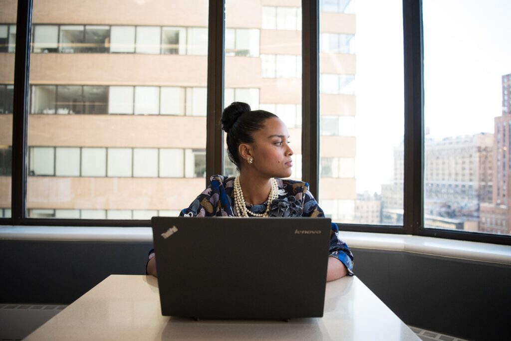 Woman of colour pondering career cushioning