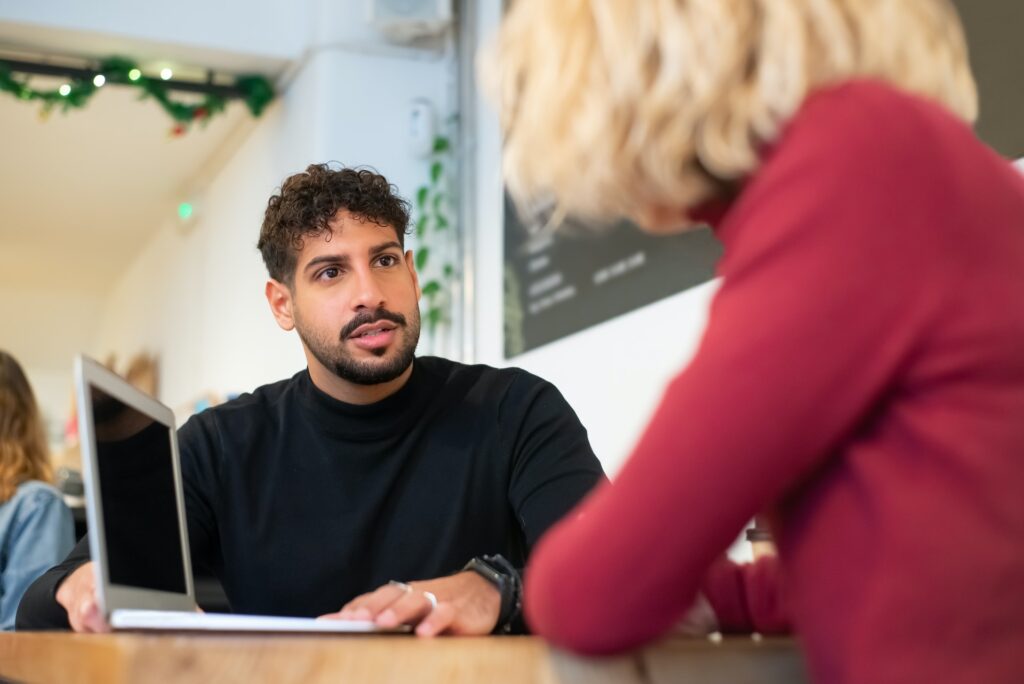 Man giving peer feedback to woman