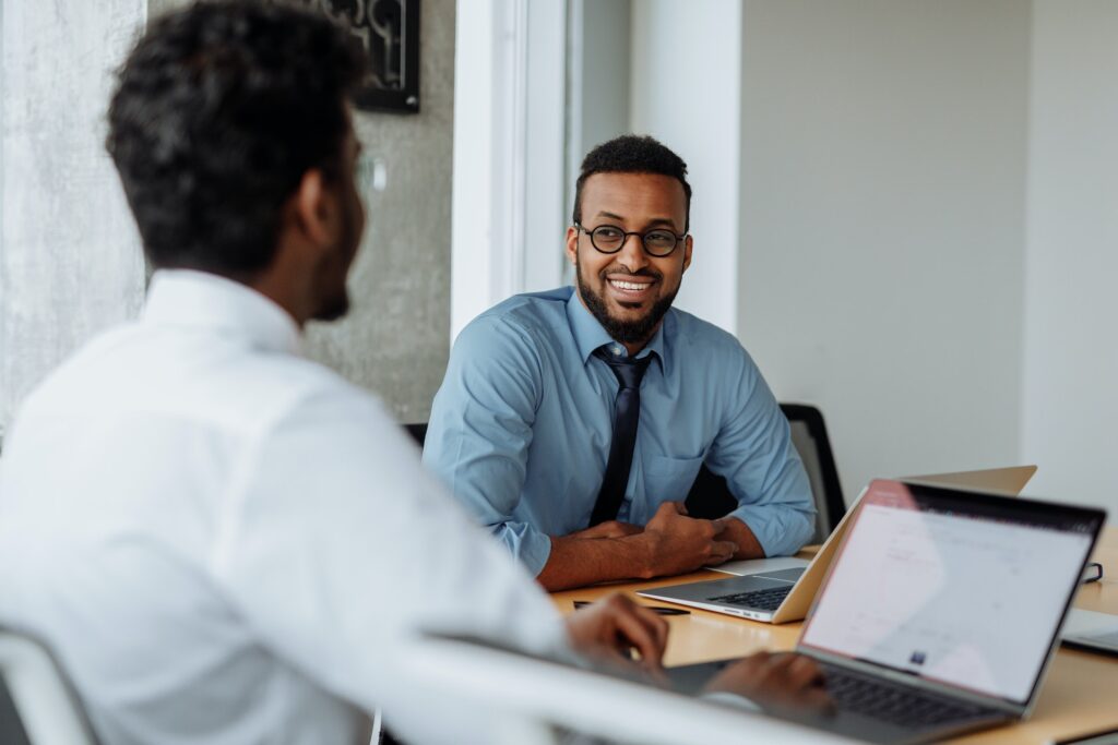 Two men of colour exchanging peer feedback