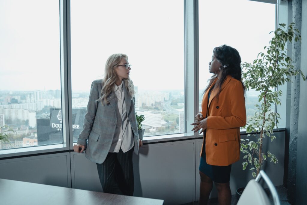 Two professional women discussing feedback in communication