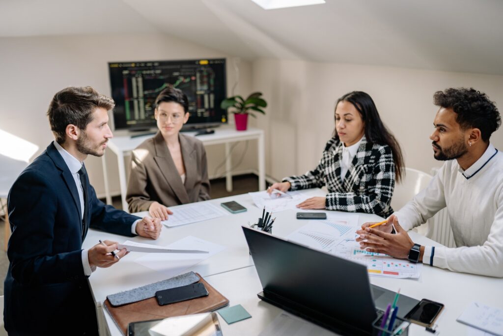 Four diverse colleagues meeting about anonymous employee feedback