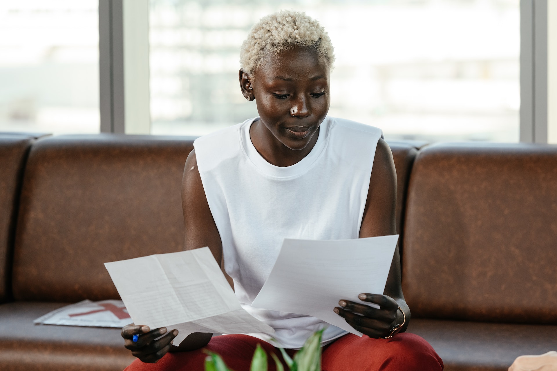 black-woman-seat-paper Black woman holding documents