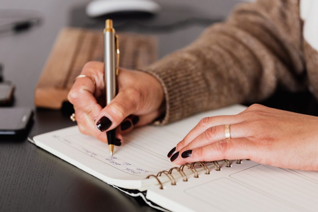 Closeup of manager's hands writing goals