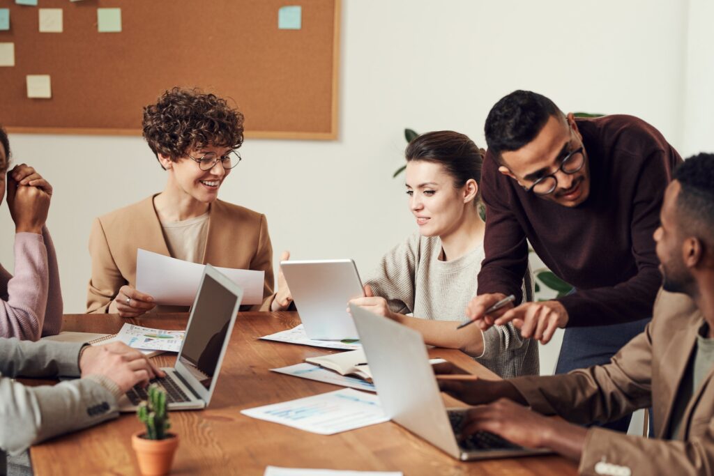 Happy, diverse group of coworkers meeting about manager goals
