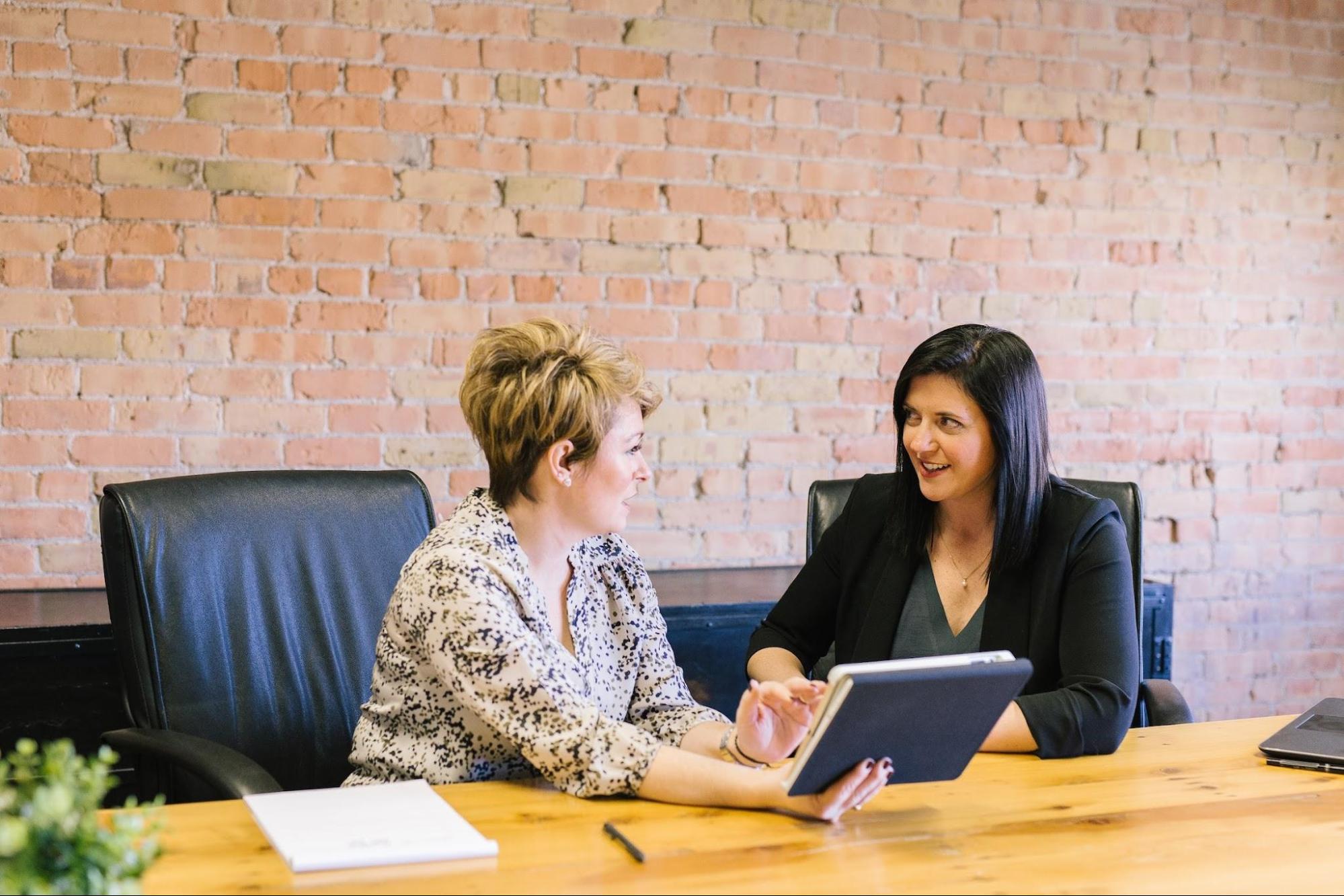 two-women-office Two women colleagues discussing a bad performance review