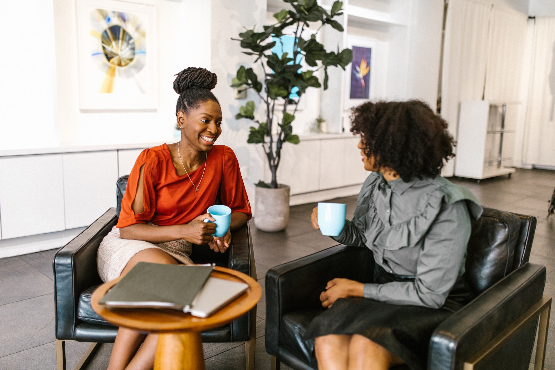 two-women-black-office- Two Black professional women discussing a leadership assessment