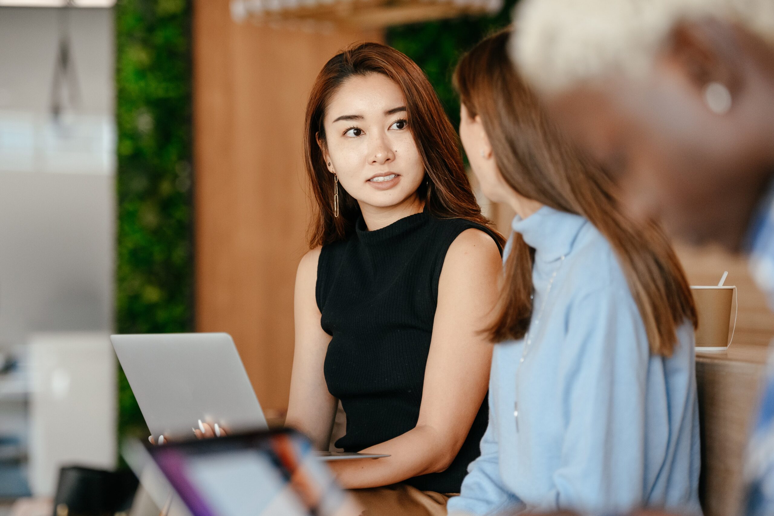 asian-woman-discussing-business-plan-with-diverse-colleagues A manager and an employee are discussing the employee performance improvement plan.