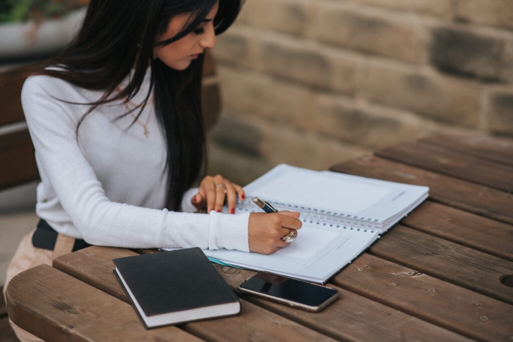 A young employee looking over her own performance improvement plans.