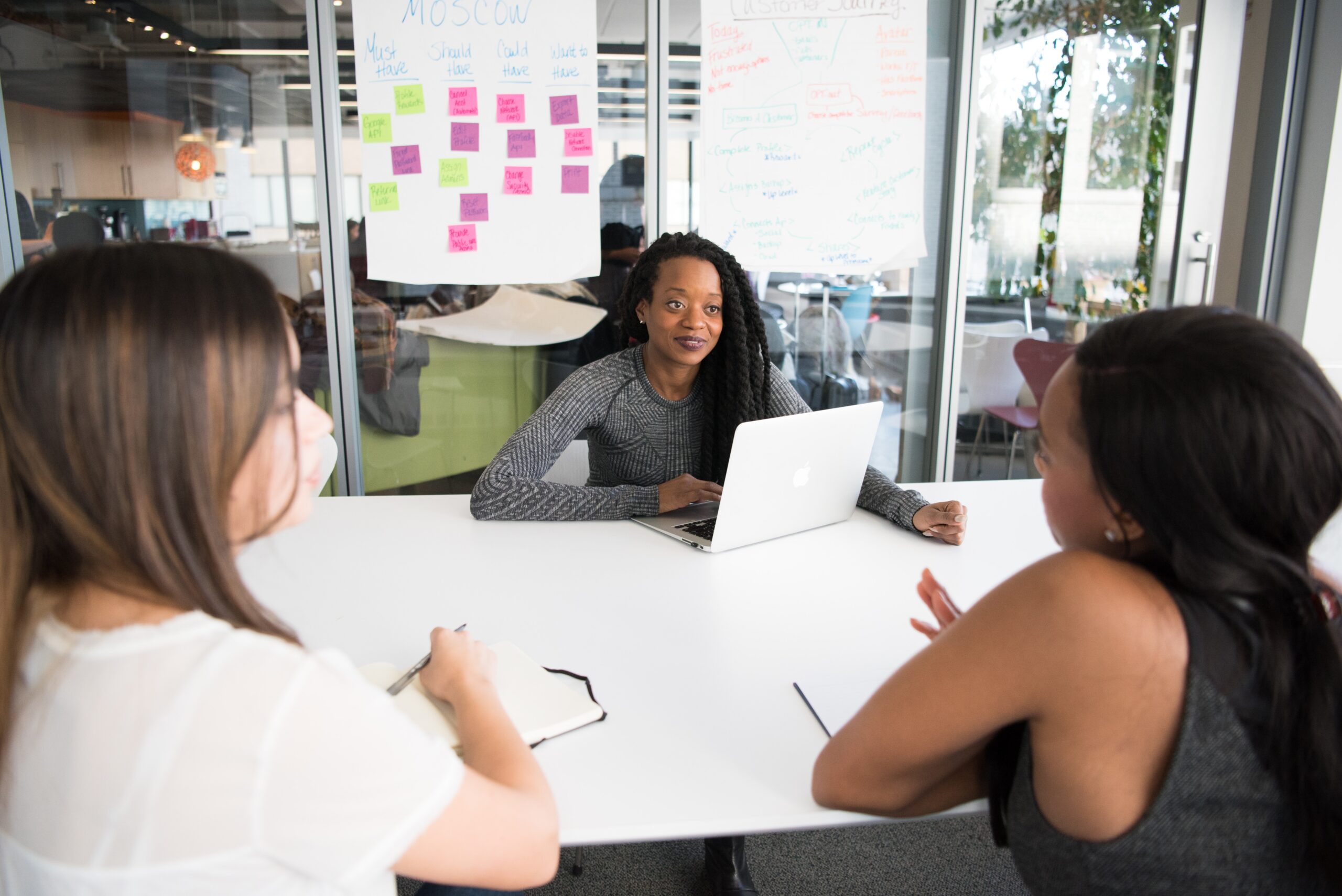 three-women-having-a-meeting HR managers discussing how to get more consistent performance management processes