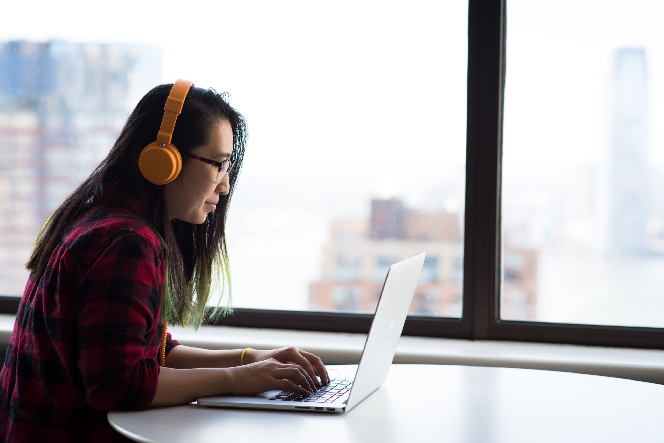 photography-of-woman-using-laptop Employee working at her laptop.
