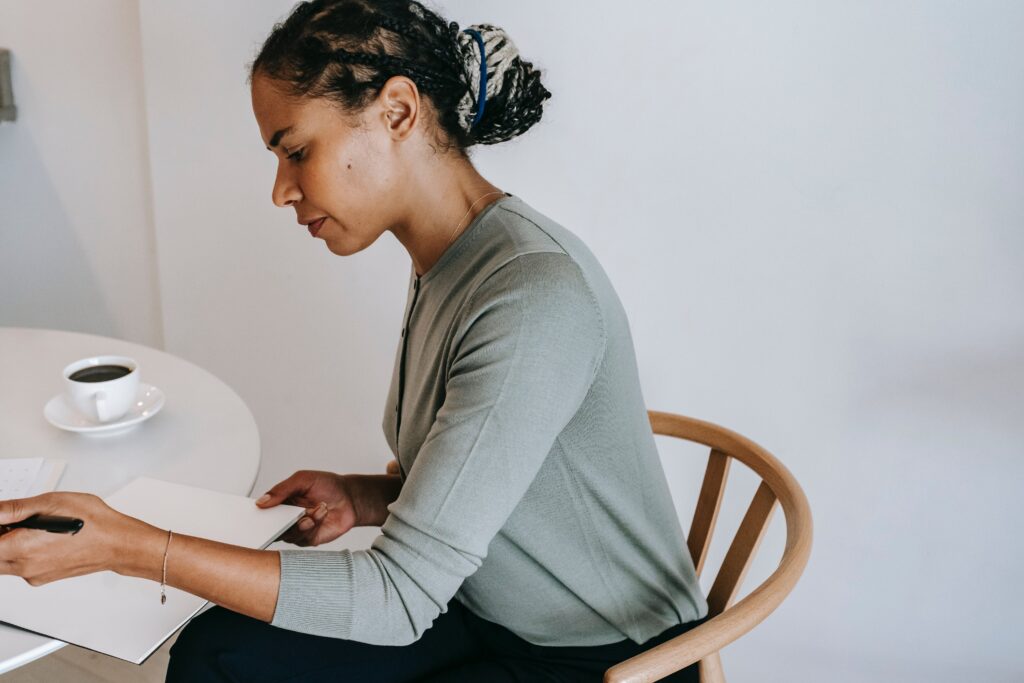 An employee completing her self-performance review at a round table