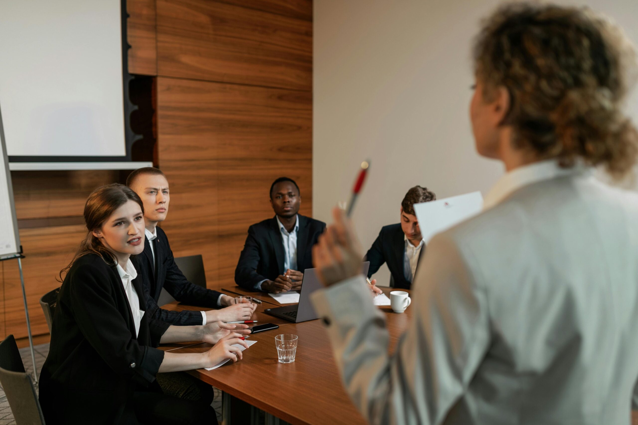 woman-in-beige-business-suit-holding-red-and-silver-ballpen A manager speaking to her employees about healthier workplaces