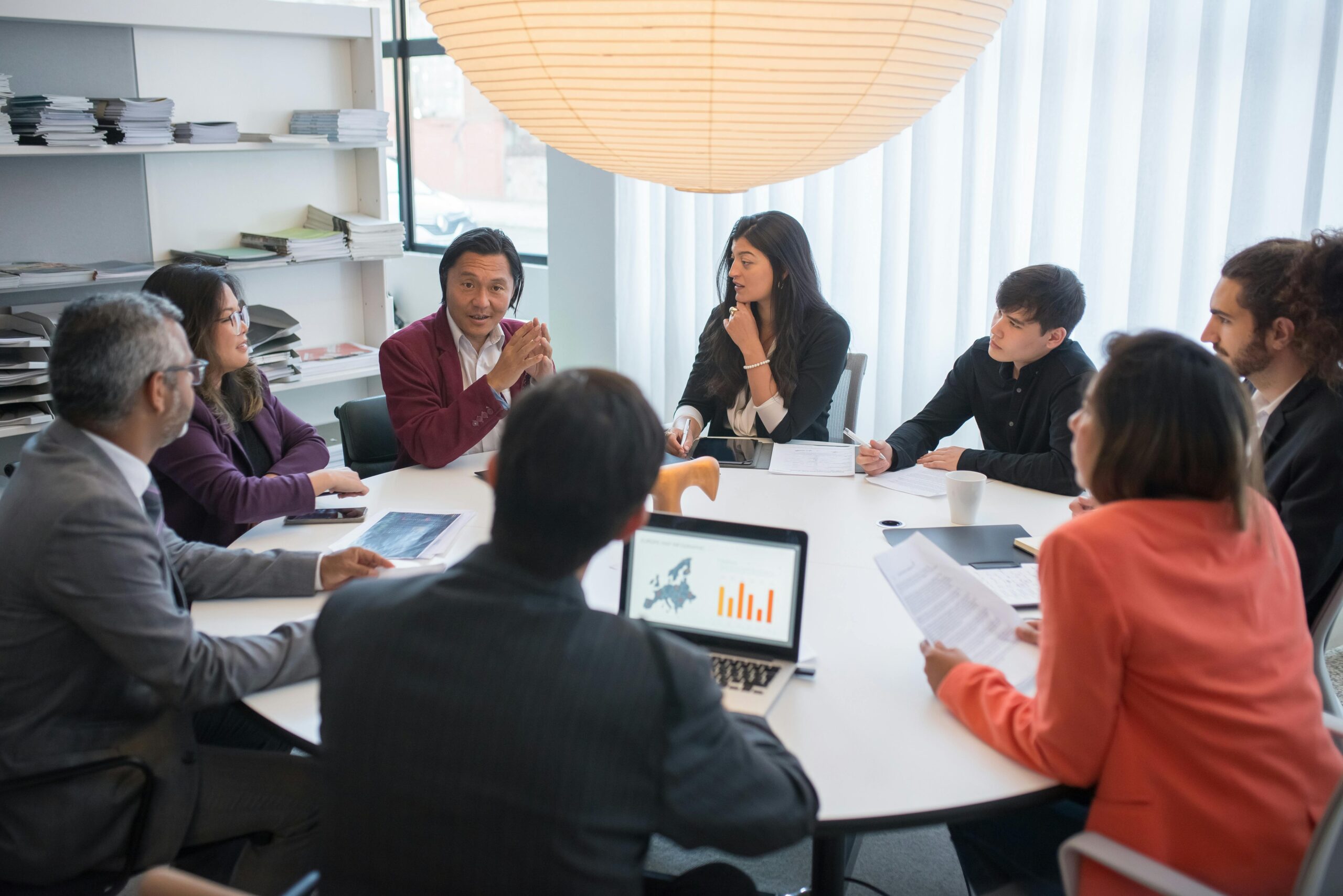 people-sitting-at-the-table People from diverse backgrounds attending a meeting