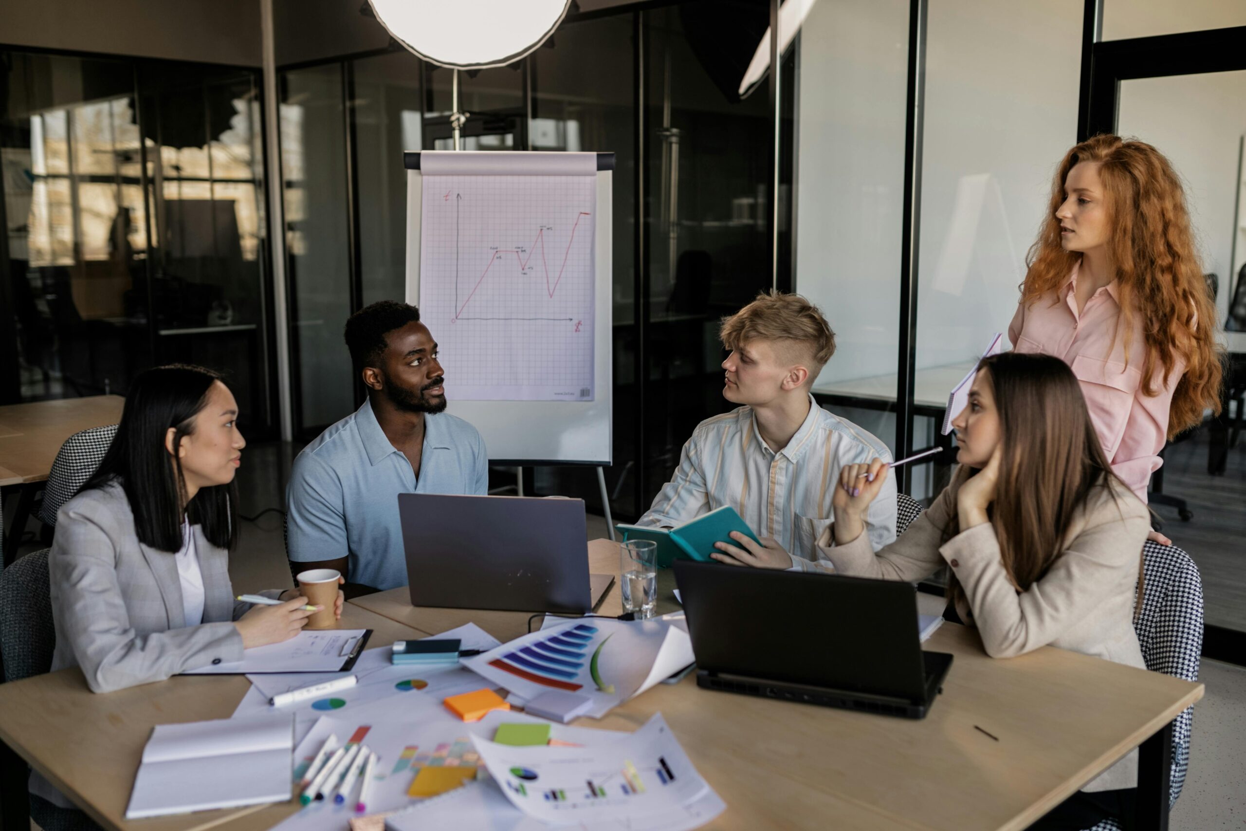 a-group-of-people-having-a-meeting-in-the-office Employees having a business meeting
