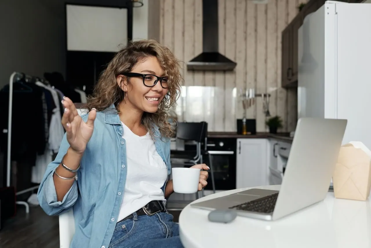 woman-at-home-working-at-table Employee in a remote meeting