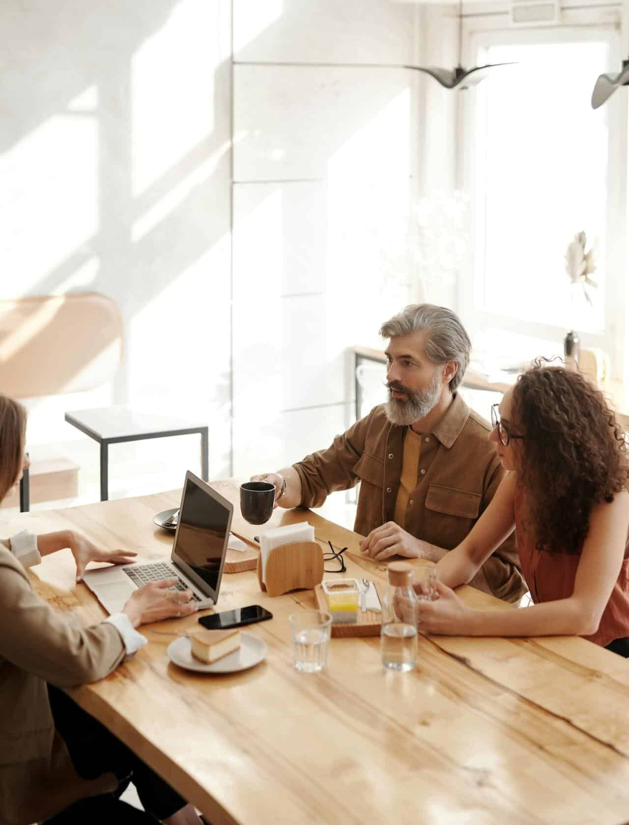 Employees coming out of a meeting and smiling